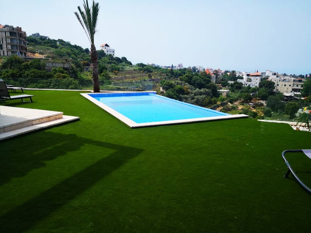 Artificial grass installation around a swimming pool in Lebanon